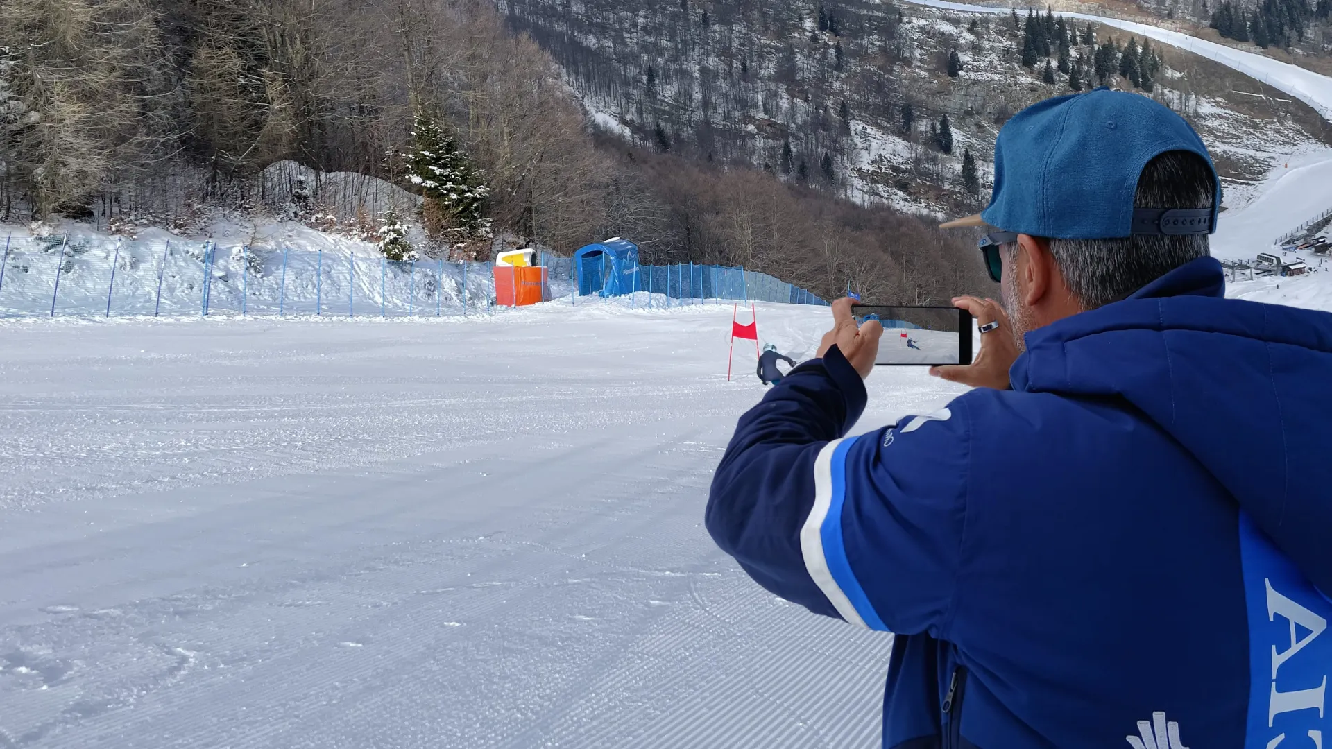 A coach records a run on a training slope